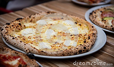Four cheese pizza Quattro Formaggio on wooden table, Italian cuisine Stock Photo