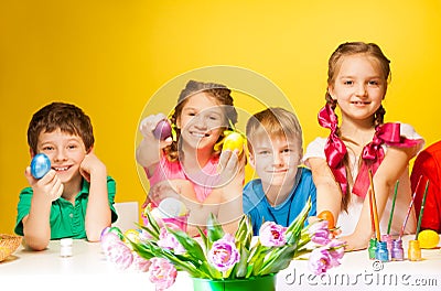 Four children holding coloured Easter eggs Stock Photo