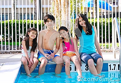 Four children by the pool side Stock Photo
