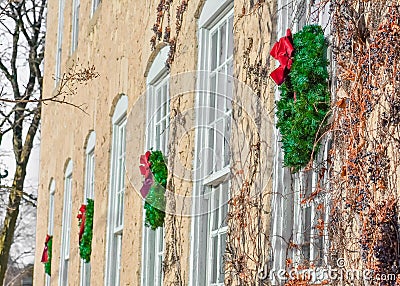 Four Christmas Wreaths Hanging on Building Stock Photo