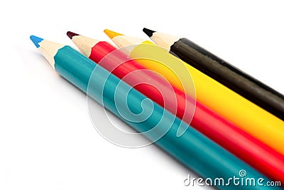 Four colored pencils. The colors cyan, magenta, yellow and black. The concept of polygraphy Stock Photo