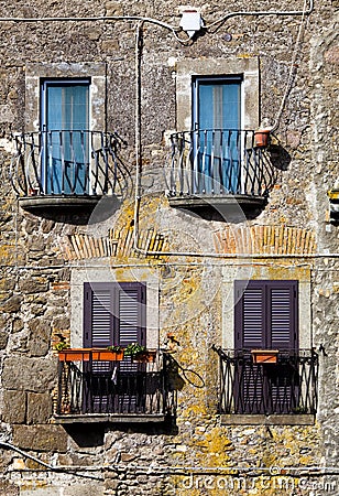 Four colored windows with balcony. Old italian vintage style. Stock Photo