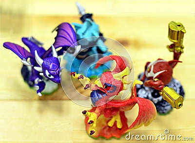 Four colorful toy dragons appear in a game of fighting. Editorial Stock Photo