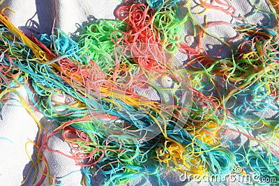 Mess of colored noodles on white cloth Stock Photo