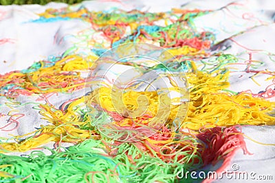 Mess of colored noodles on white cloth Stock Photo
