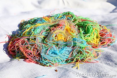 Mess of colored noodles on white cloth Stock Photo