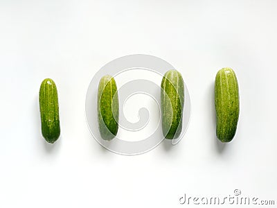 Four cucumbers from small to big Stock Photo
