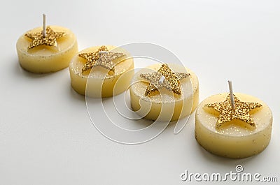 Four decorative candles with star pattern Stock Photo