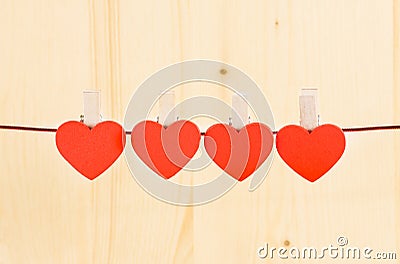 Four decorative red hearts hanging on wood background, concept of valentine day Stock Photo