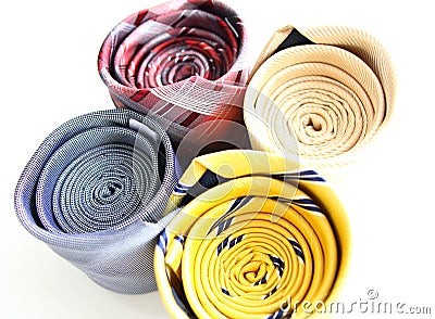 four different rolled color luxury ties Stock Photo