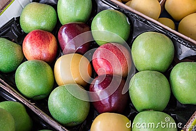 Four different types of ripe apples in a box. Stock Photo