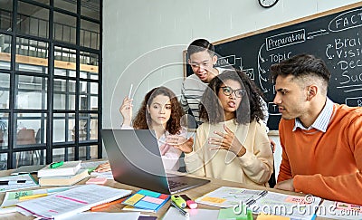 Four diverse coworkers brainstorming discussing project in contemporary office. Stock Photo