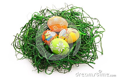 Four easter eggs in a nest isolated on white Stock Photo