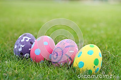 Four eggs painted pastel line in the grass background. Stock Photo