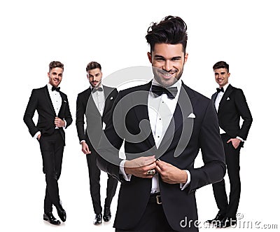 Four elegant man with leader buttoning his tux in front Stock Photo