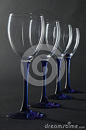 Four empty blue wine glasses Stock Photo