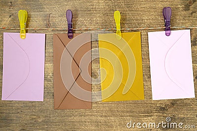 Four envelopes hang with clips and rope Stock Photo