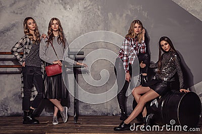 Four fashion models girl full length portrait in casual clothes. Stock Photo