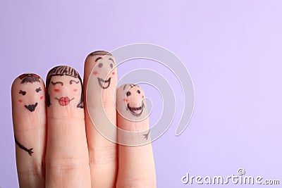 Four fingers with drawings of happy faces on violet background, space for text Stock Photo