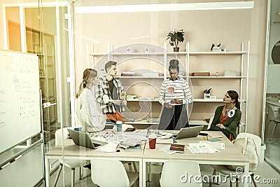 Four freelancers using thinking hats for discussing new project Stock Photo