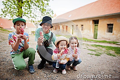 Four funny children eat ice cream outdoor Stock Photo