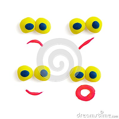 Four funny faces - eyes and mouths - made of multicolored plasticine with different expressions on the white background. Stock Photo