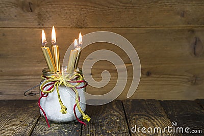 Four golden candles, traditional christmas decoration on a woo Stock Photo