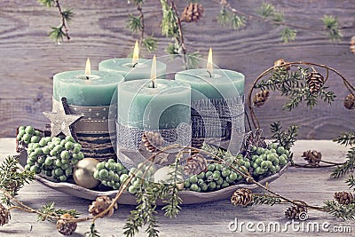 Four green christmas candles Stock Photo