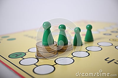 Game board green figures on money pile Editorial Stock Photo