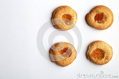 Four handmade cookies with apricot jam arranged in even rows with free space for text on white background Stock Photo