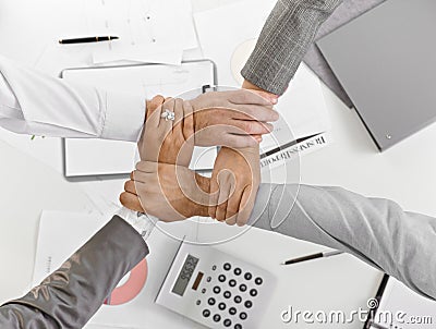 Four hands together in unity at businessmeeting Stock Photo