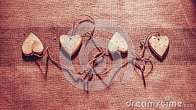 Four hearts linked together with rope Stock Photo