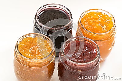 Four jars of different jam on white background, top view Stock Photo