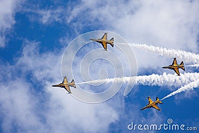 four jets fly in formation through the sky leaving white smoke coming from the back Editorial Stock Photo