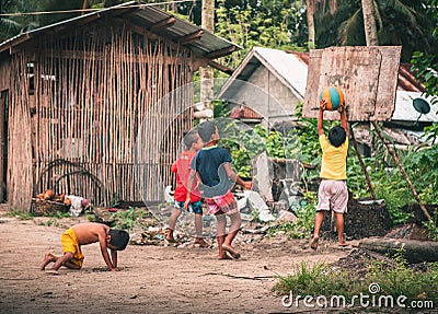 Four kids playing basketball in the jungle Editorial Stock Photo