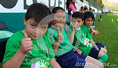 Four kids salutes to the camera in a sport event in mexico Editorial Stock Photo