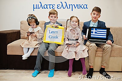 Four kids show inscription learn greek. Foreign language learning concept Stock Photo