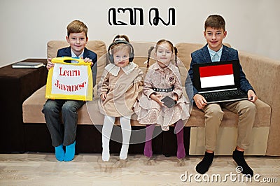 Four kids show inscription learn javanese. Foreign language learning concept Stock Photo