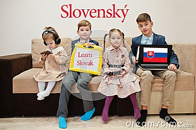 Four kids show inscription learn slovak. Foreign language learning concept. Slovensky Stock Photo