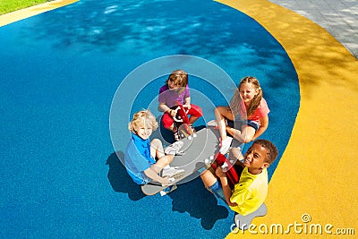 Four kids sitting on carousel view from top Stock Photo