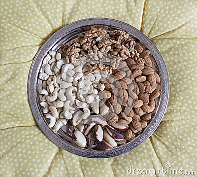 Four kinds of peeled nuts on a silver tray. Walnuts, cashew, Brazil nuts, almonds Stock Photo