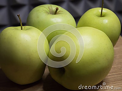 Four large apples, close-up. Fruit on a wooden surface Stock Photo