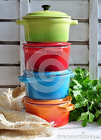 Four little colorful cooking pots and linen texture Stock Photo