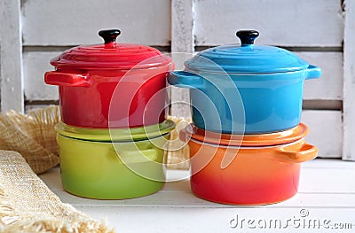 Four little colorful cooking pots and linen texture Stock Photo