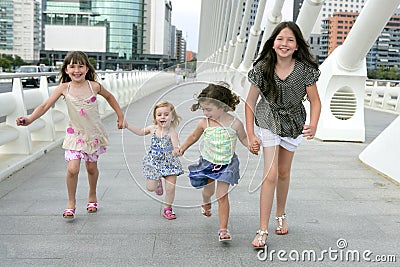 Four little girl group walking in the city Stock Photo