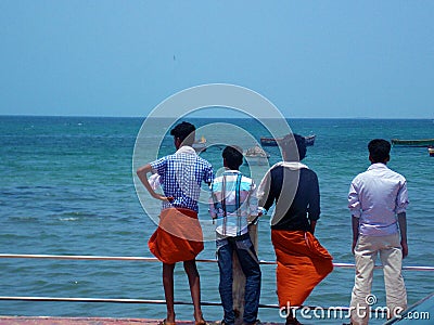 Four man looking at ocean outside Minakshi Temple Madurai Editorial Stock Photo