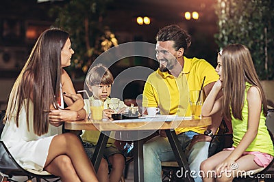 Four member family having great time in a restaurant Stock Photo