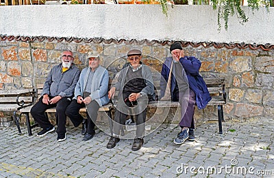 Four Men sitting on a bench in a old Turkish Village Editorial Stock Photo