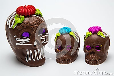 Four Mexican Calaverita de azucar Candy Skull and Calaverita de Chocolate, Stock Photo