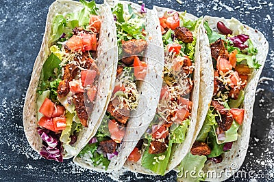 Four mexican tacos on a black background Stock Photo